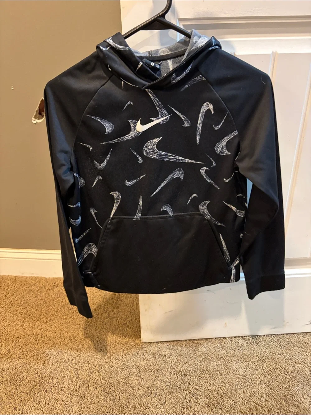 Nike Black Hoodie with White Swoosh Pattern